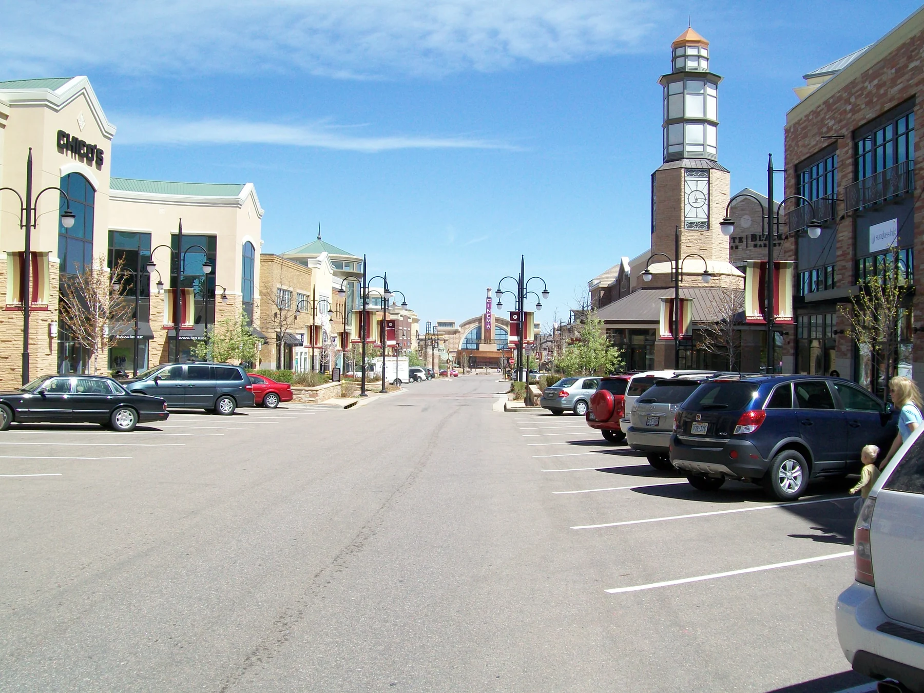 Aurora shopping street with brick storefronts and a clock tower