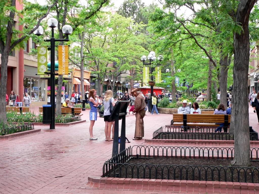 Shoppers beneath leafy trees on Pearl Street Mall in Boulder