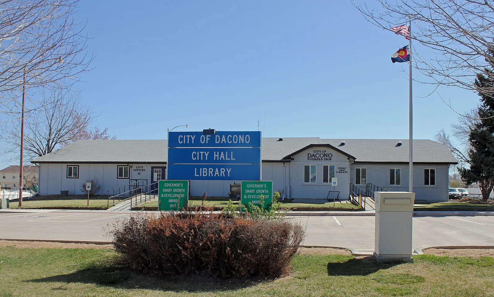 Dacono city hall and library buildings and signs on Cherry Street in Colorado