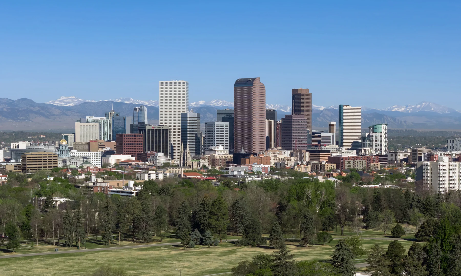 Downtown Denver skyline with the Rocky Mountains behind it