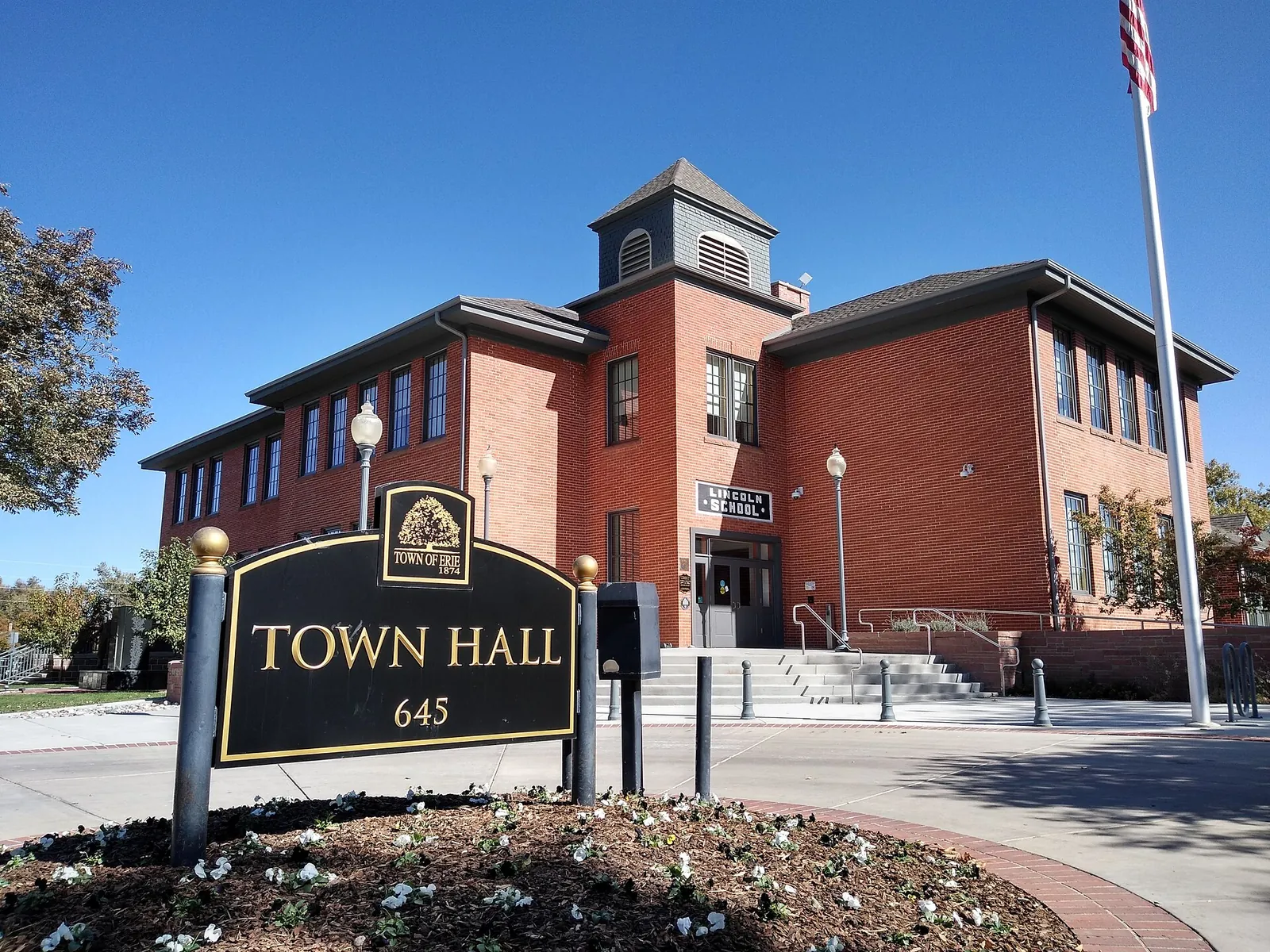 Brick Erie Town Hall building and sign at the former Lincoln School in Erie, Colorado