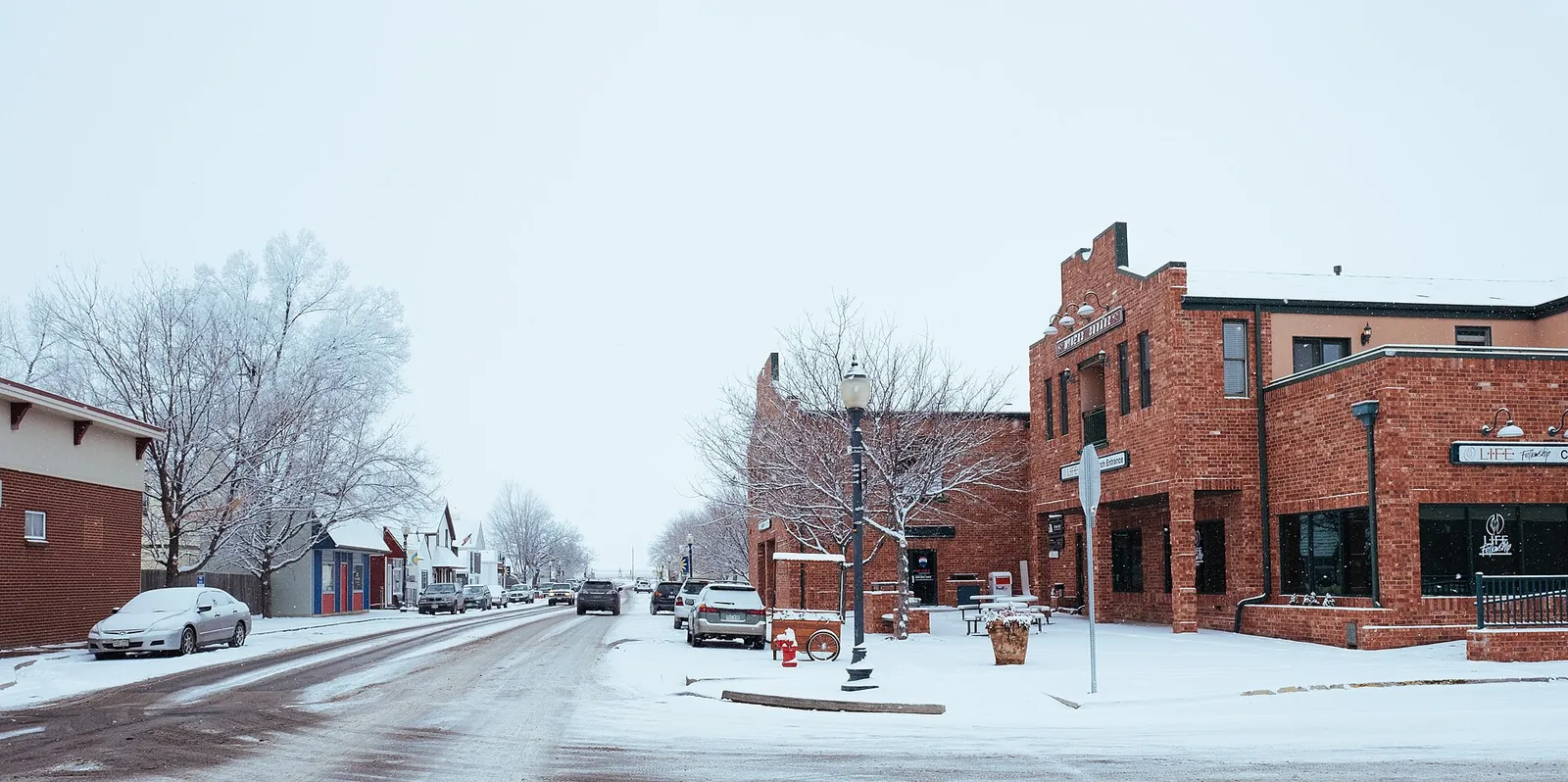 Snow-covered downtown storefronts at Oak and 5th Street in Frederick, Colorado