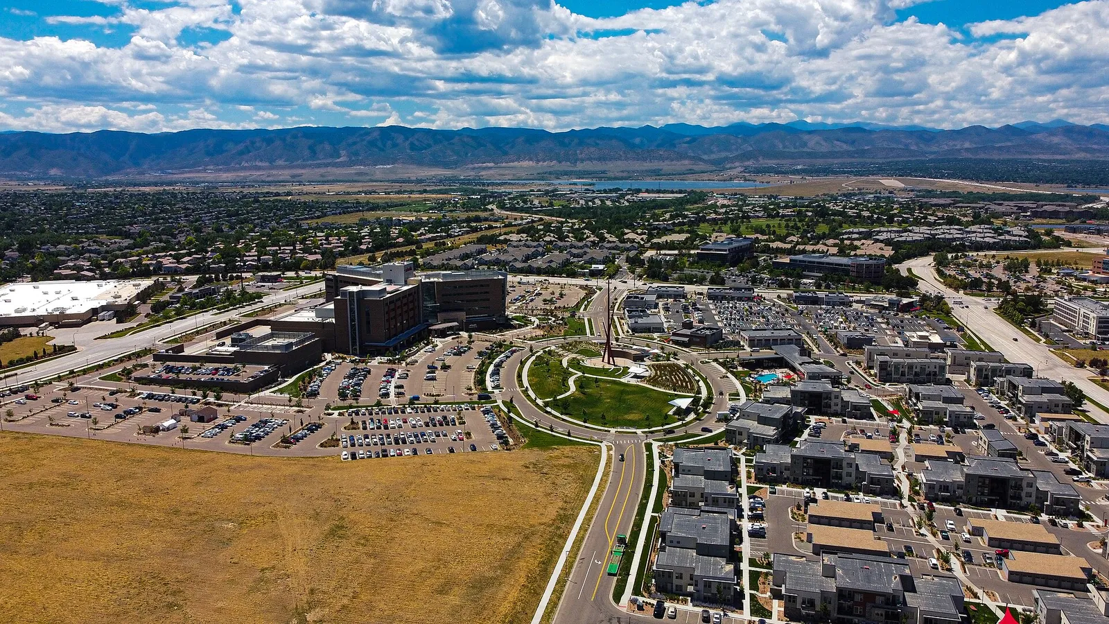 Aerial view of Highlands Ranch neighborhoods and green spaces with the Front Range beyond