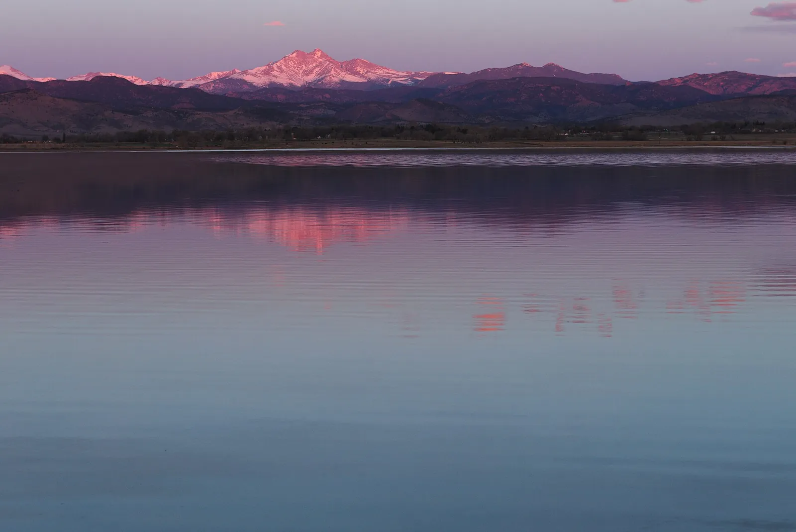 Mount Meeker reflected in McIntosh Lake at sunrise in Longmont, Colorado