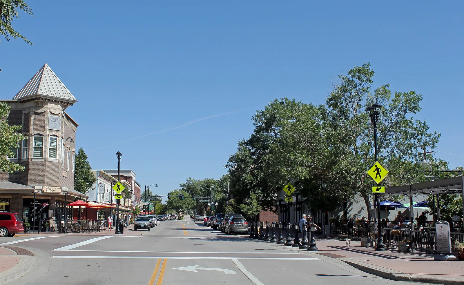 Mainstreet in Parker, Colorado, lined with shops, trees and a clock tower