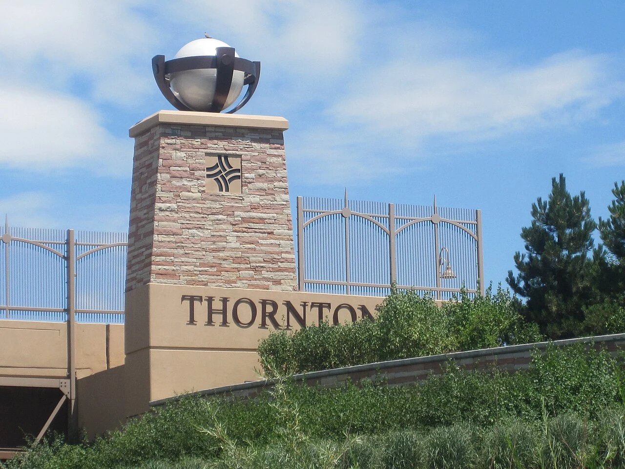 Stone Thornton welcome monument beneath a blue Colorado sky